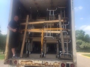 A trailer filled with more than 600 student desks and chairs from Witt Elementary School, packed for shipment to the World Compass Charter School.